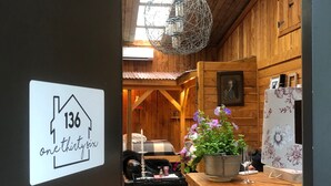A wooden interior with a sign indicating room number 136.
