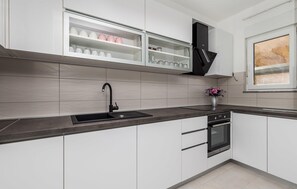 Fridge, stovetop, dishwasher, coffee/tea maker