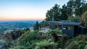 Una casa moderna con una terraza que da a un valle.