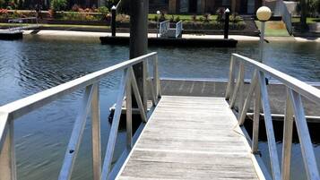 Stroll along the dock, taking in the serene views of the calm water.
