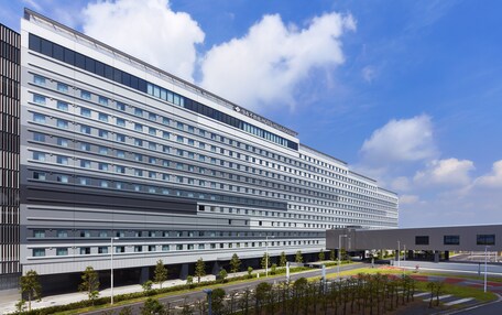 A modern hotel building with multiple floors, large windows, and a flat roof.