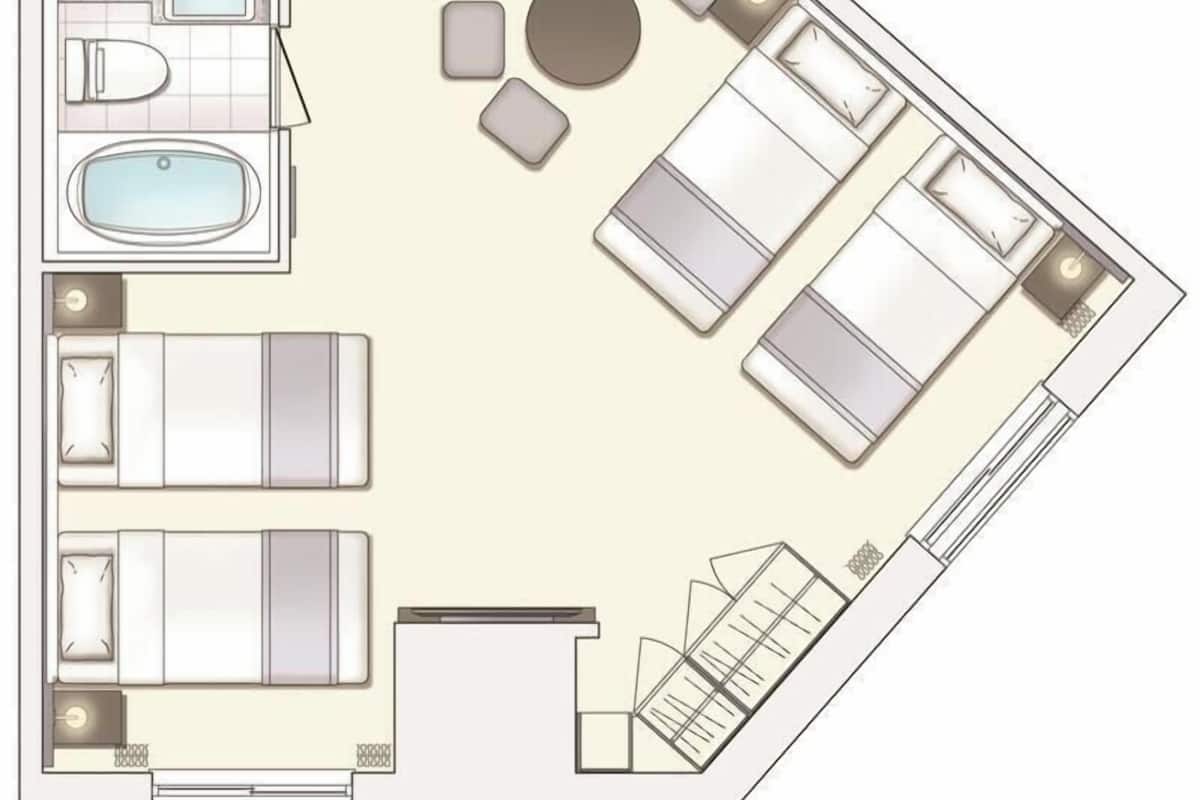 Ein Hotelzimmer mit Bett, Bad, Sitzecke und kleinem Balkon.