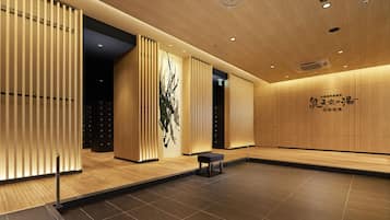 A modern interior with wooden paneling, a bench, and a wall with text.
