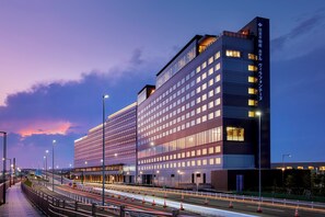 A modern hotel with multiple floors and a prominent entrance.