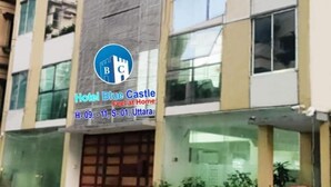 A multi-story building with a sign for Hotel Blue Castle. - Hotel Blue Castle (Dhaka)