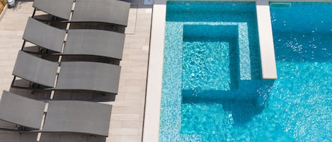 Seasonal outdoor pool, open 7:00 AM to 10:00 PM, sun loungers