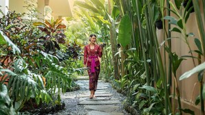 A person walking down a stone pathway surrounded by lush tropical plants. - The Kalyana Ubud Resort (Ubud)