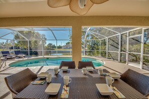 Relax by the pool surrounded by expansive views of the surrounding landscape and enjoy a meal at the dining table.