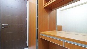A wooden wardrobe with a mirror and a door. - Jo Rooms - Apartemen Betos (Bekasi)