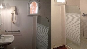 Un baño con lavabo, toallero y cabina de ducha.