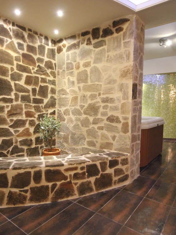 Relax in a cozy corner with a potted plant and a small table, surrounded by a comfortable and inviting atmosphere.