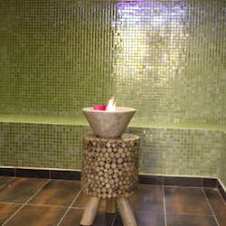 A cozy space with a candle holder and lit candle.