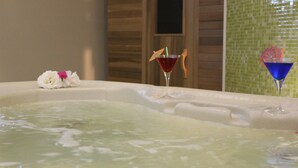 A hot tub with two drinks, one red and one blue, and a flower on the edge. - The Magnolia Resort - Adults Only (Kefalonia)