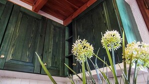 A rustic kitchen with green wooden cabinets and a tiled backsplash. - Traditional Charming Stone Chalet (Distomo-Arachova-Antikyra)