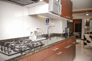 Fridge, microwave, stovetop, coffee/tea maker