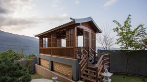 A traditional Japanese-style wooden structure with a stone base, wooden railing, and a stone lantern. - Jia Xin Hot Spring Resort Yangming Shan (New Taipei City)