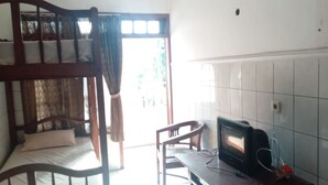 A room with a bunk bed, a desk with a television, and a chair. - Wisma & Kantin Amanda (Pacet)