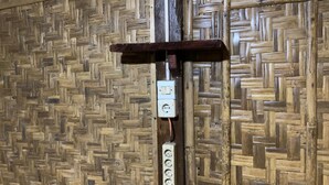 Pared con un diseño tejido y una estructura de madera con un tablero de interruptores.