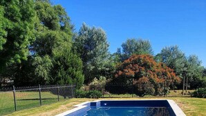 A rectangular swimming pool with a tiled edge and a surrounding deck. - The Lancefield Lodge (Lancefield)