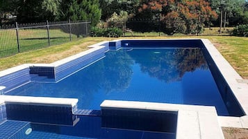 Seasonal outdoor pool, pool loungers