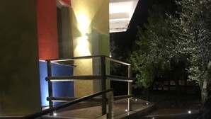 A modern building with a glass staircase leading to a covered outdoor area. - SUITE LA GINESTRA among historic olive trees (Eboli SALERNO)