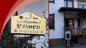 Un edificio con un letrero que dice "Landgasthof Göwen" y "DINKELACKER".