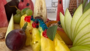 A fruit platter with various fruits and decorative elements on a wooden board. - Beachfront Cabana @ EcoBeach Hotel (Gennadi)