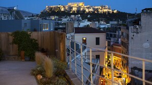 A view of a cityscape with a historic castle-like structure on a hill, modern buildings in the foreground, and a clear sky. - Impressive Apartment with Amazing Views in Athens City Centre! MK1 (Athens)