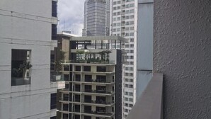 A modern high-rise building with multiple floors, large windows, and balconies. - Luxury Deluxe Studios At Mercu Summer Suites (Kuala Lumpur)