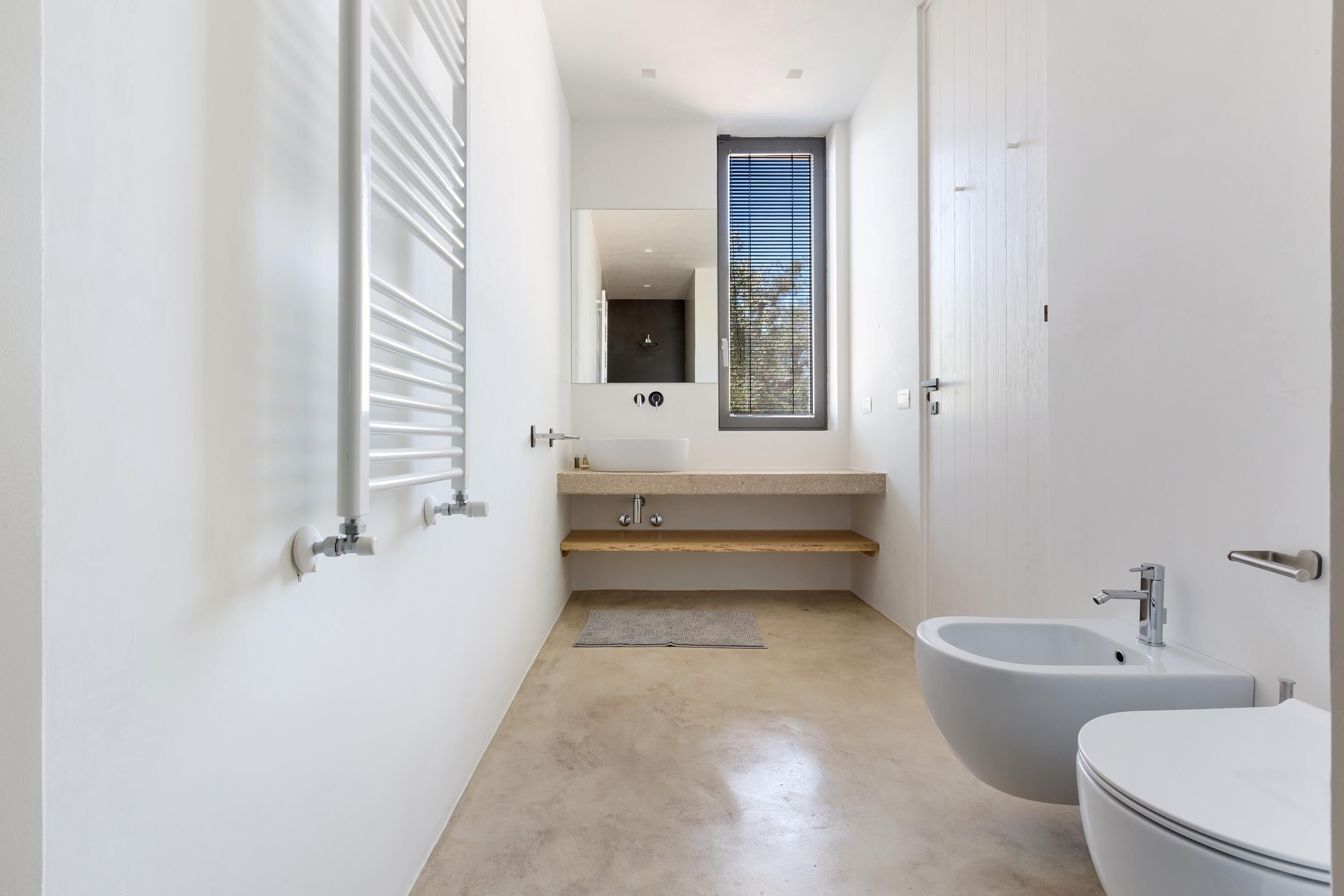 A modern bathroom with a bathtub, sink, and toilet.