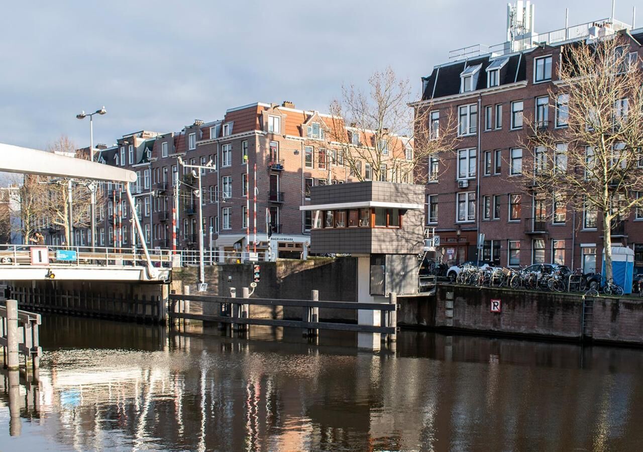 Un canal flanqueado por edificios a un lado y un puente al otro.