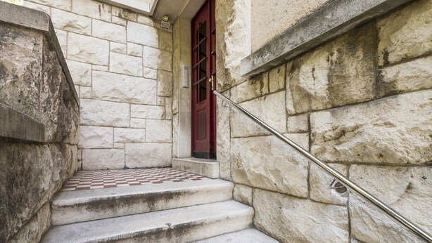 A stone staircase with a red door and a metal handrail. - Apartment Dinka with terrace (Split)