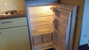 A kitchen with a built-in refrigerator, a stove, and a sink.