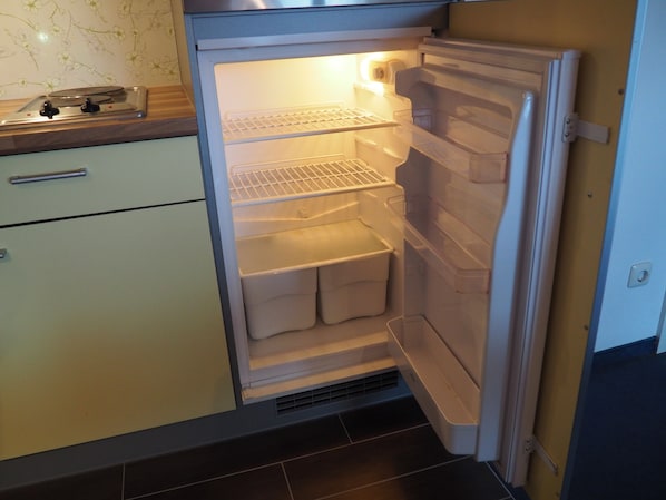 A kitchen with a built-in refrigerator, a stove, and a sink.