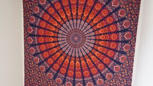 A tapestry with a circular pattern on a wall.