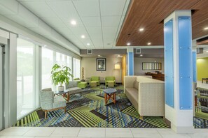 A modern lobby with a patterned carpet, seating areas, and large windows. - Holiday Inn Express & Suites Lindale – Tyler by IHG (Lindale)