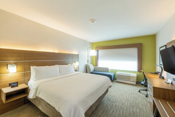A hotel room with a large bed, a desk with a computer, a TV, and a window with a view. - Holiday Inn Express & Suites Lindale – Tyler by IHG (Lindale)
