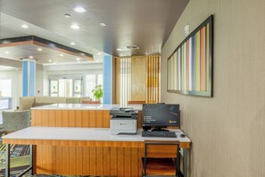 A reception desk with a printer, computer, and seating area. - Holiday Inn Express & Suites Lindale – Tyler by IHG (Lindale)
