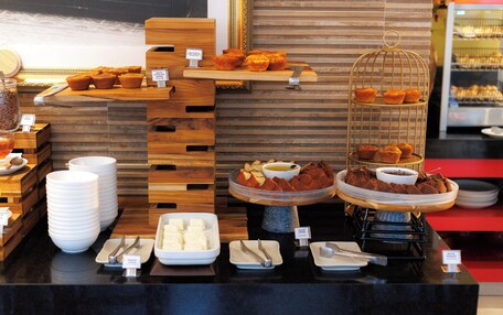 A buffet with various food items and serving utensils.