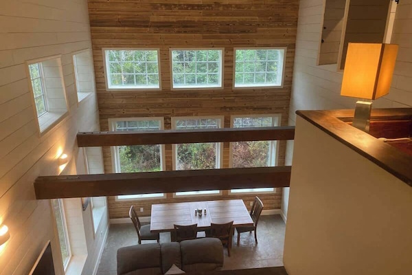 This a view from the 4th level, which is the game room looking down into the great room. The office is on the right and the entrance to the master bedroom and en-suite is just to the right of the desk. You can see the shutters on the right that open