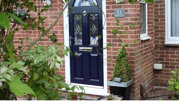 A dark blue door with the number 31, a small window, and a brick wall with a sign reading "Queen's Road". - Queens Road Rental - Winchester Accommodation (Winchester)