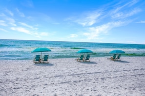 A beach with three turquoise umbrellas and matching lounge chairs facing the ocean. - BEACHFRONT l PRIVATE BEACH l BEACH SET UP INCLUDED l STUNNING WATER VIEWS (Santa Rosa Beach)