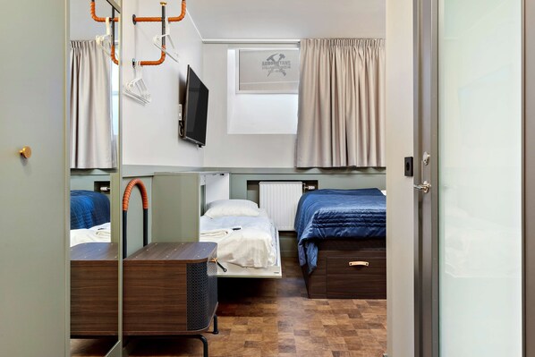 A compact room with two beds, a small table, and a TV. - Best Western Hotel at 108 (Stockholm)