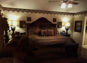 Cozy retreat with a traditional bed, bedside tables, and lamps.