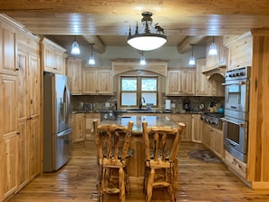 Enjoy cooking in this well-equipped kitchen with a central island and large window.