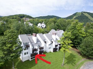 Set amidst lush greenery, this contemporary building offers a serene retreat with balconies and a well-manicured lawn.
