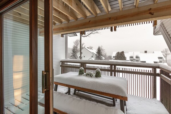 Enjoy the serene view of the surrounding houses and trees from this balcony.