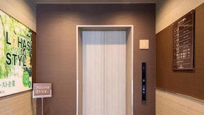 An elevator with a digital control panel, a sign indicating the floor, and a wall-mounted directory. - Super Hotel Matsumoto Ekimae (Matsumoto)