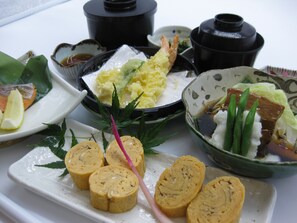 A variety of dishes including sushi, sashimi, and a bowl of rice with vegetables. - Sauna & Cupsule Cure Kokubuncho (Sendai)