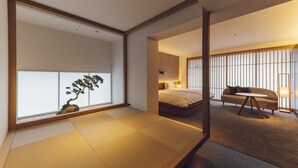 A modern hotel room with tatami flooring, a bed, a sofa, and a large window with a bonsai tree. - nol kyoto sanjo (Kyoto)